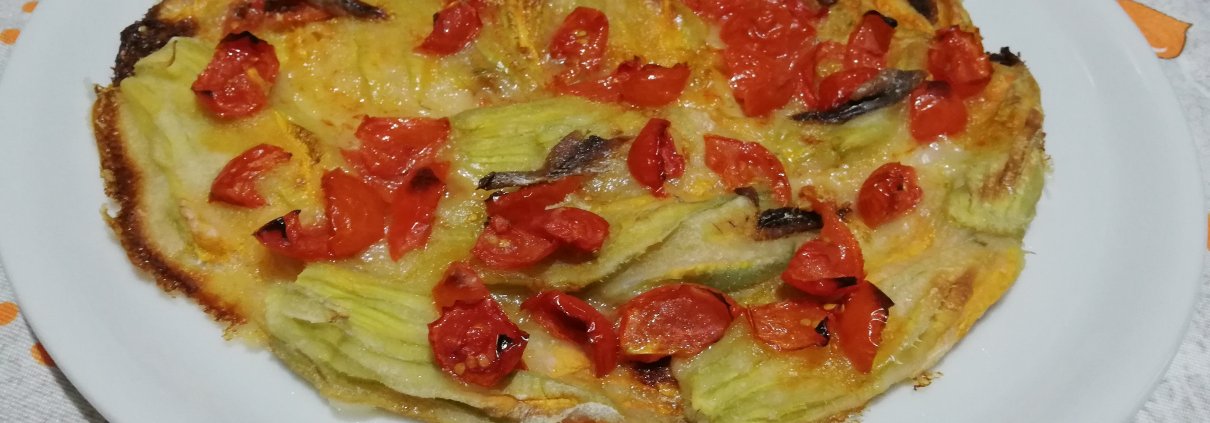 Fiori di zucca in pastella al forno con pomodorini e alici