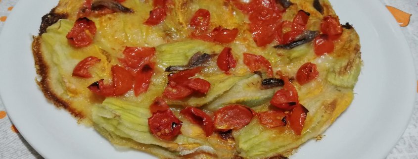 Fiori di zucca in pastella al forno con pomodorini e alici